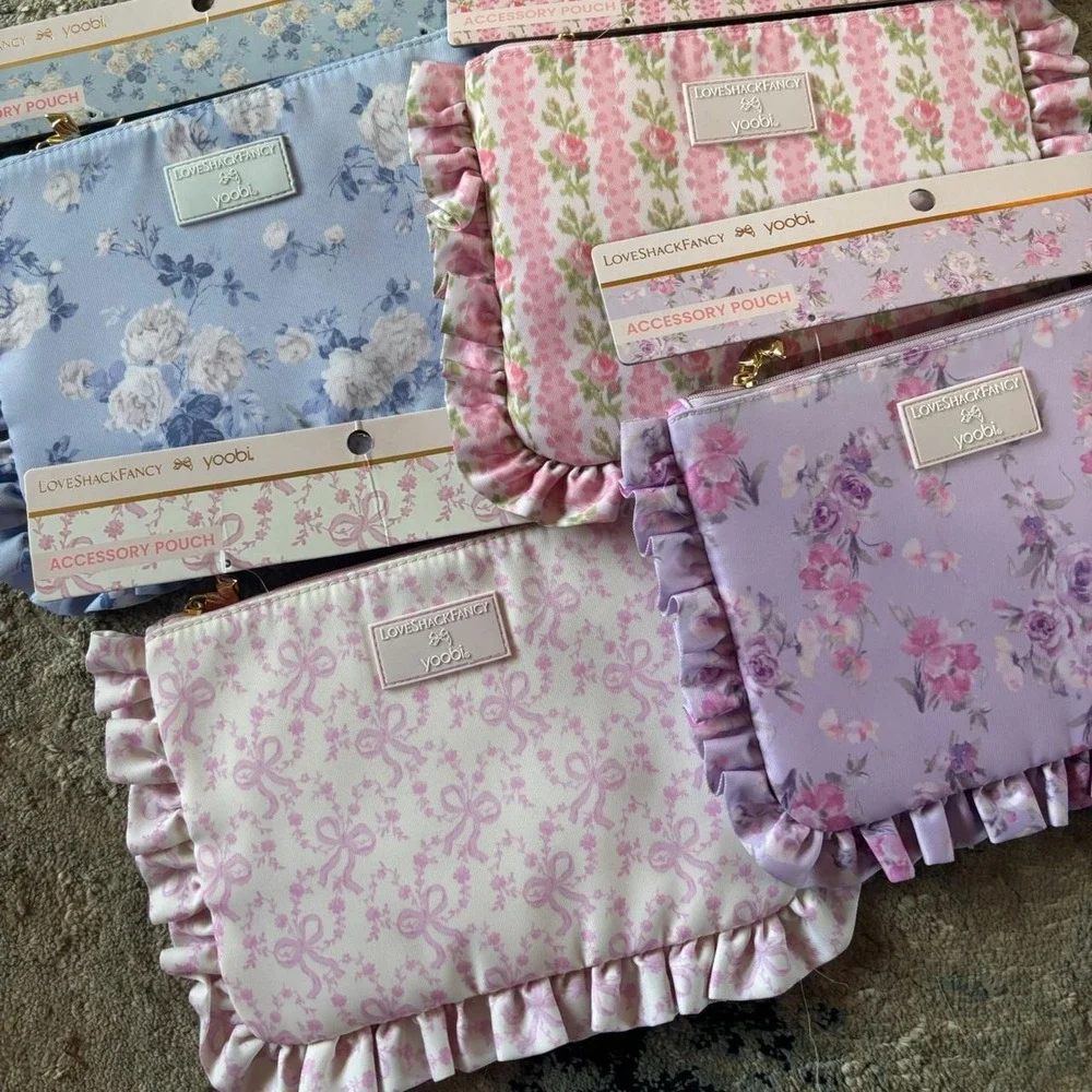 LoveShackFancy & Yoobi floral accessory pouches in pink purple blue & white bows